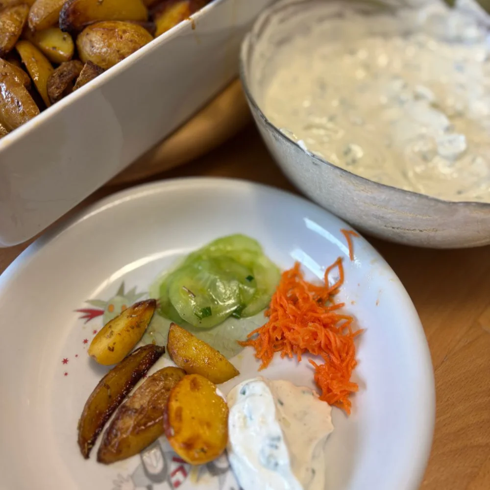 Frisches Bio-Essen für die gemeinsame Zeit am Tisch. Kartoffelspalten, Quark, Gurken und Karotten zum Genießen.